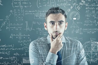 Photo of employee contemplating complex formulas