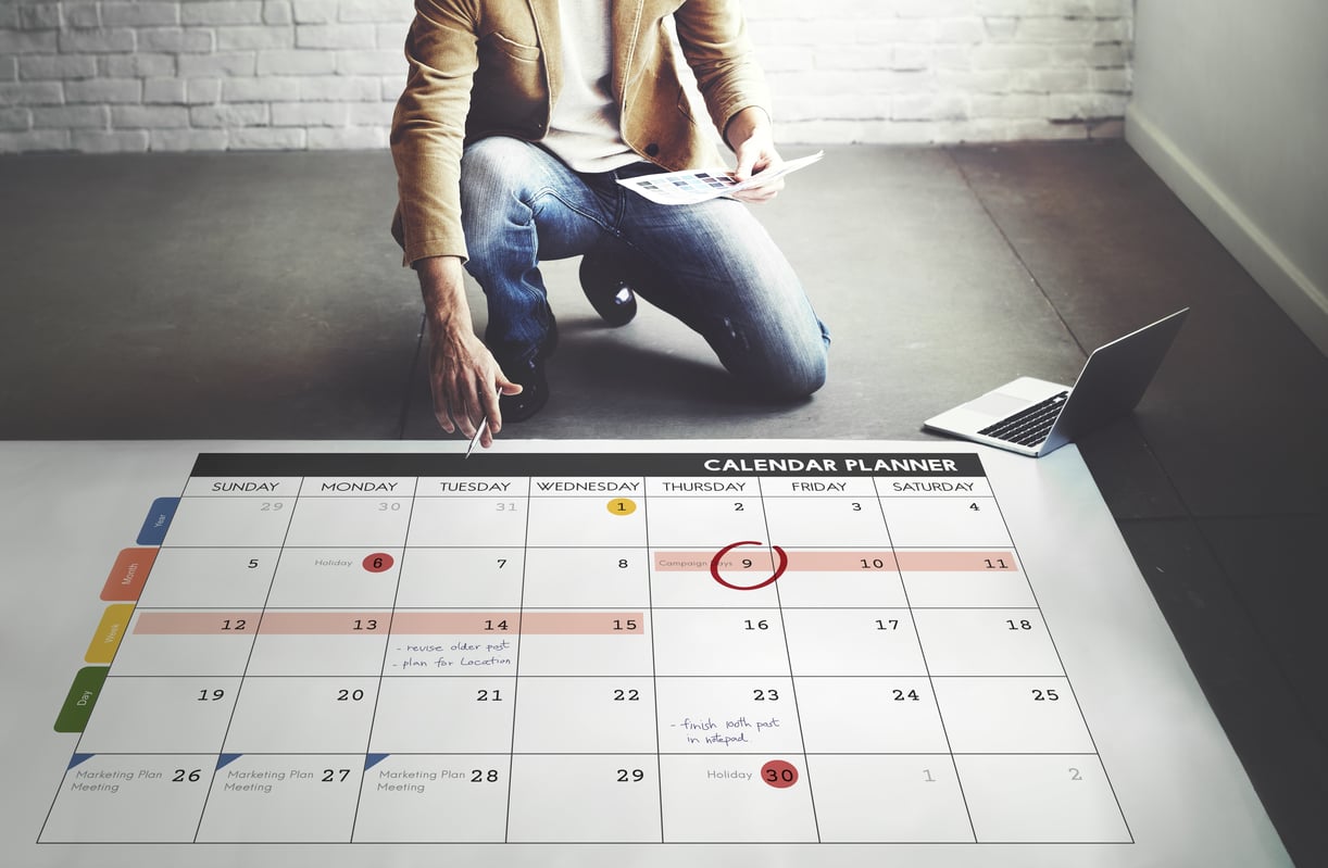 Man with Calendar creating a timeline.