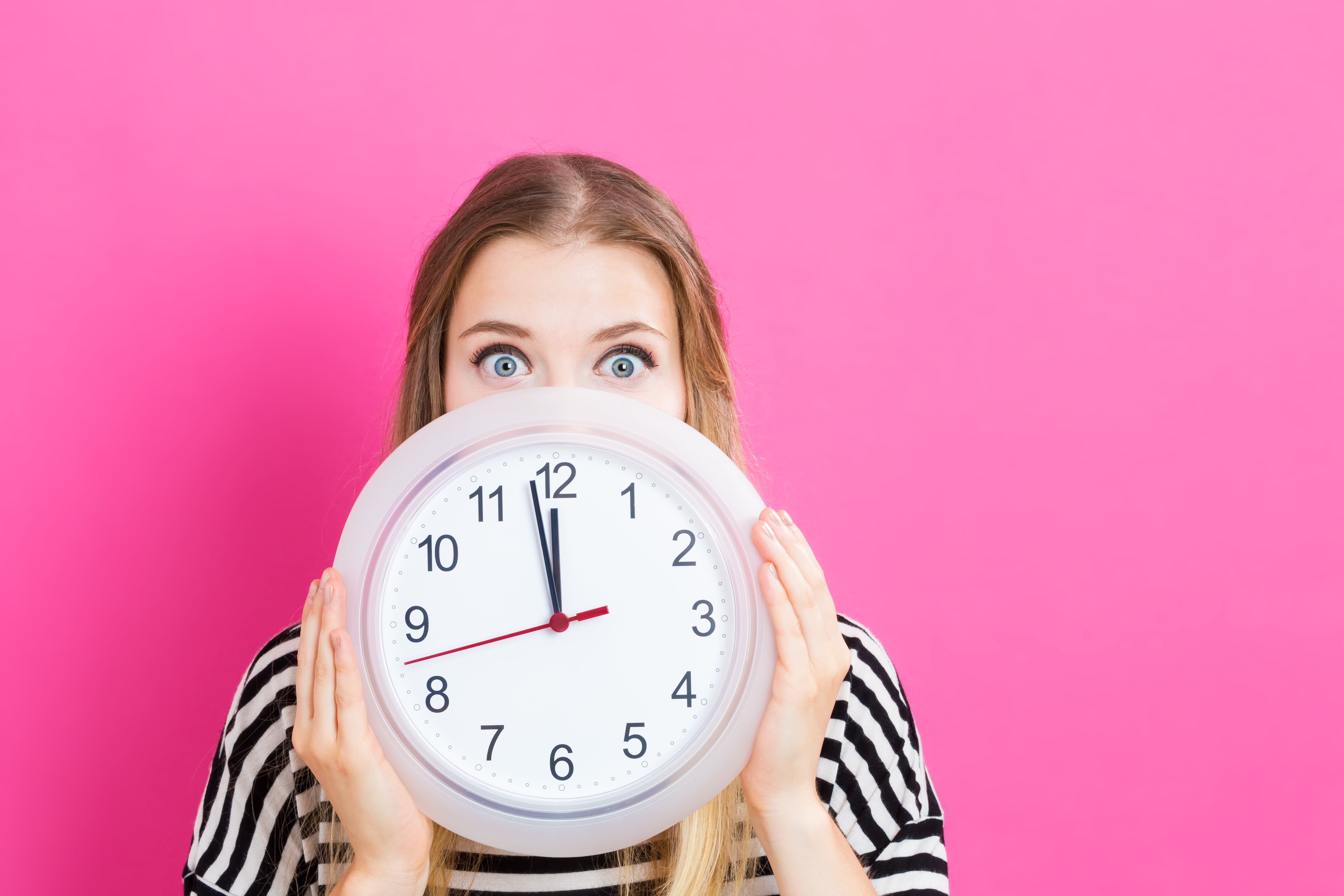 Woman holding a clock, time is running out