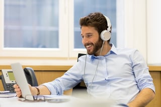 Smiling businessman looking at laptop