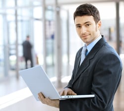 Businessman giving a demo on laptop