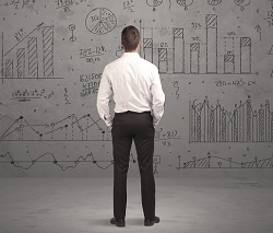 businessman contemplating large plan